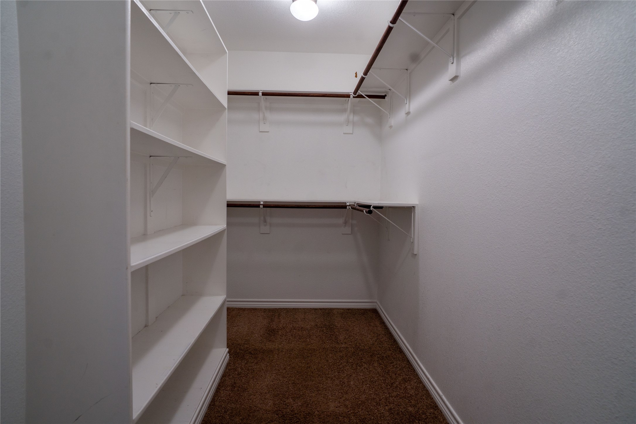 119 Hackberry Street Louise, TX 77455 - Photo 20 of 31 a view of walk in closet with empty racks