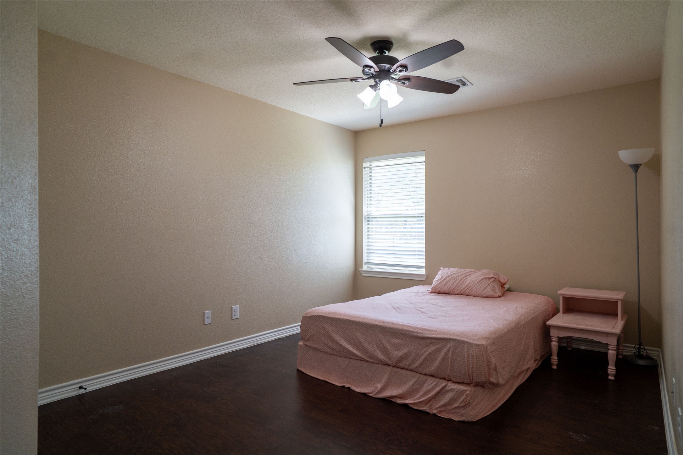 119 Hackberry Street Louise, TX 77455 - Photo 26 of 31 a bedroom with a bed and a chandelier