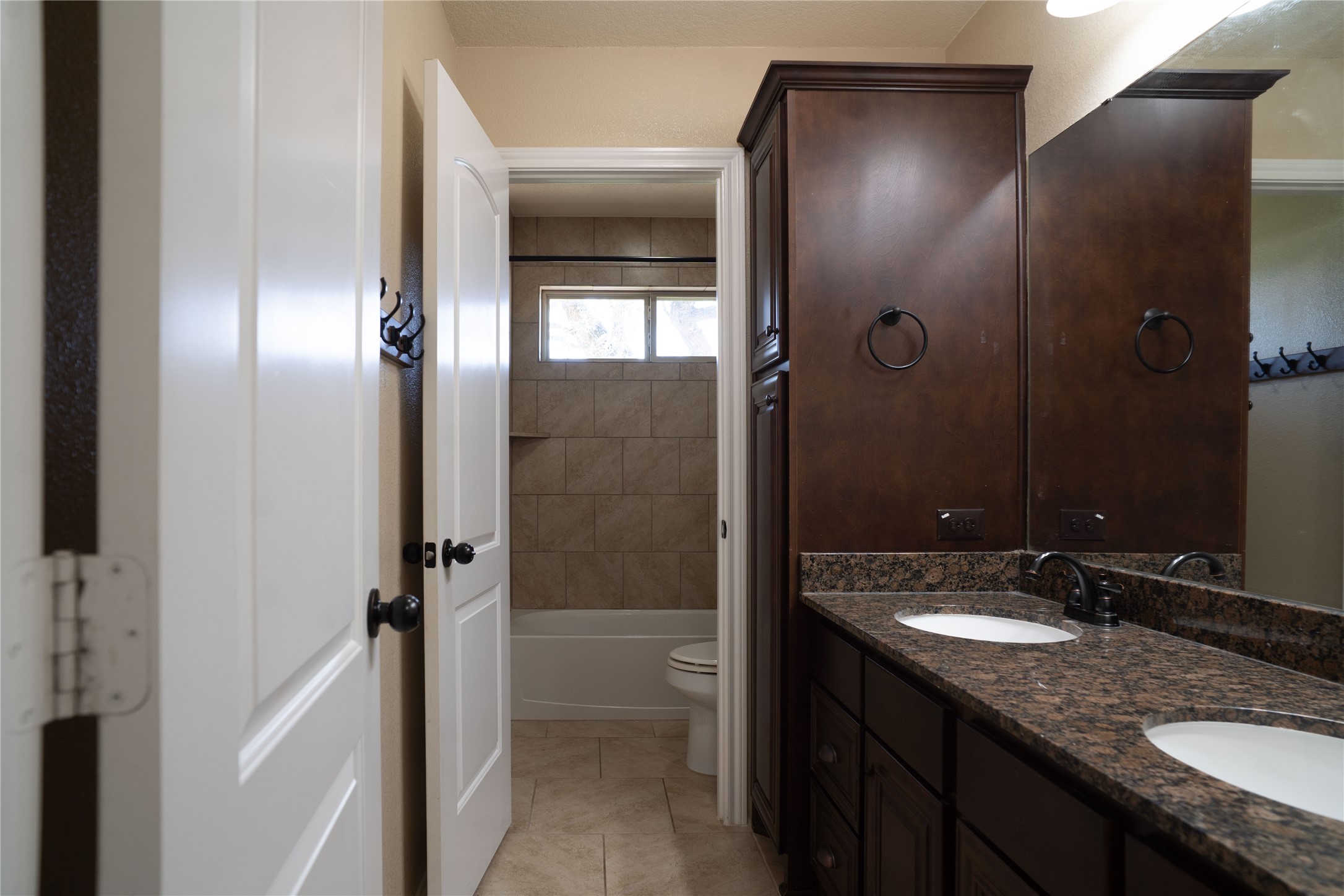 119 Hackberry Street Louise, TX 77455 - Photo 27 of 31 a bathroom with a granite countertop sink shower mirror and a toilet