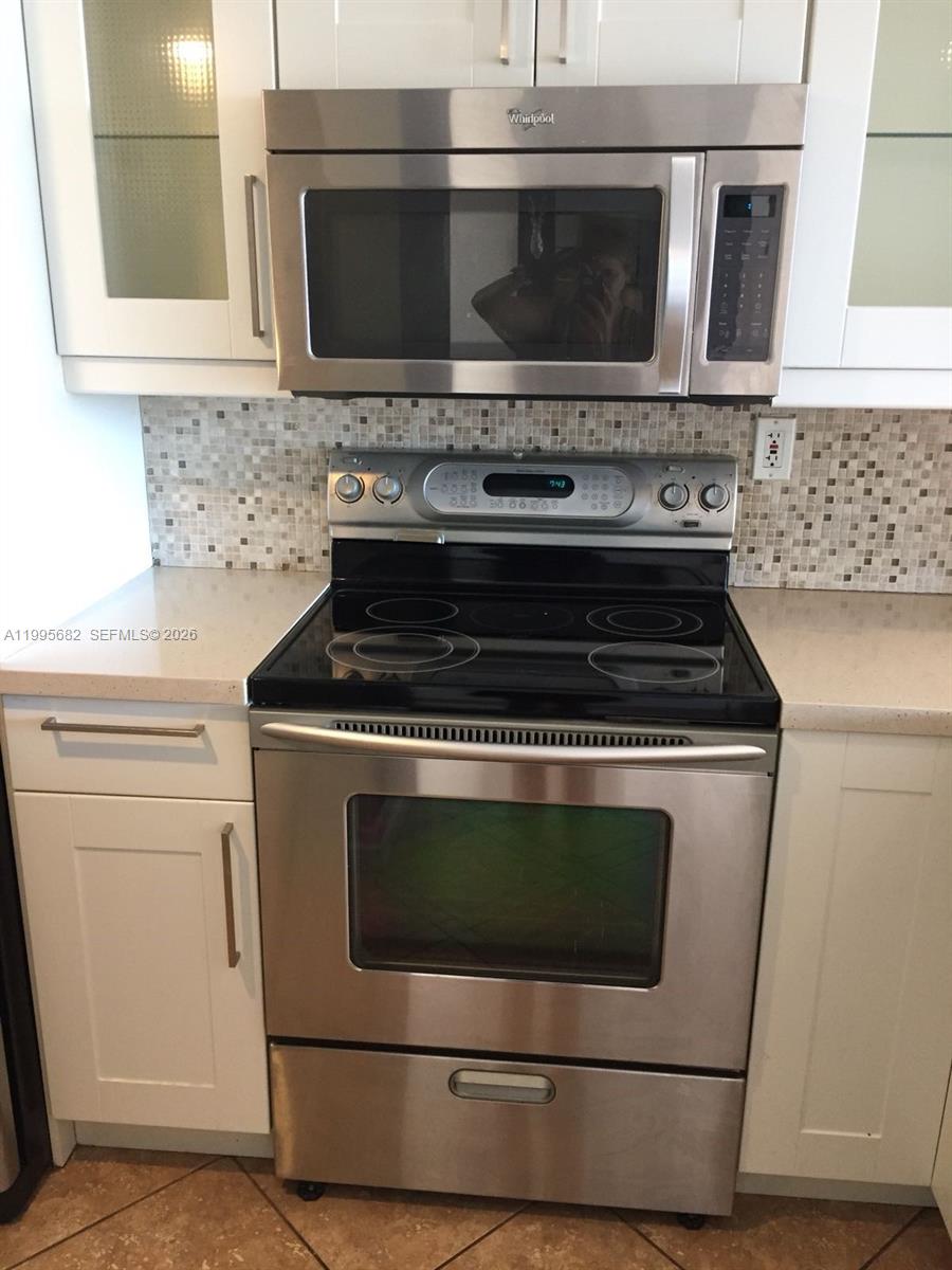 1401 Bay Road, Unit 412 Miami Beach, FL 33139 - Photo 6 of 9 a stove top oven sitting inside of a kitchen