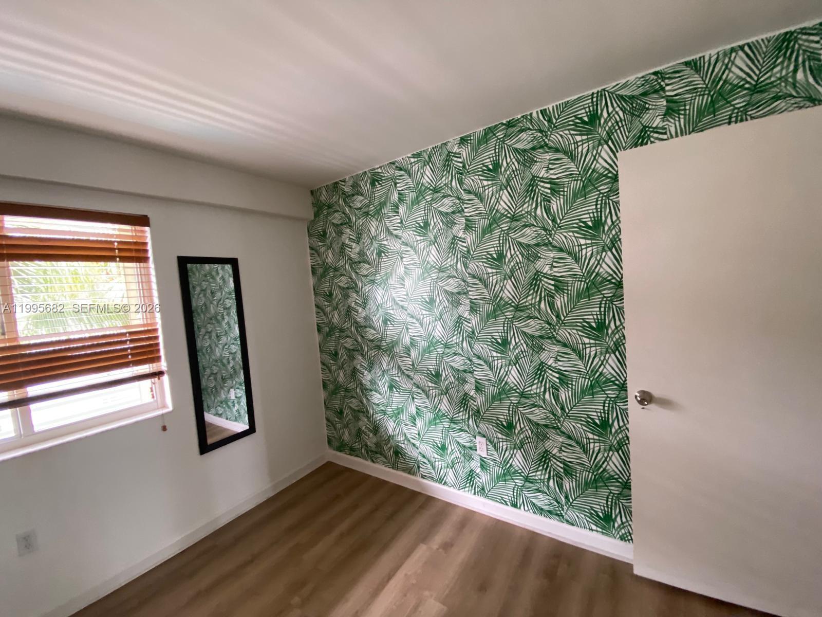 1401 Bay Road, Unit 412 Miami Beach, FL 33139 - Photo 7 of 9 wooden floor in an empty room