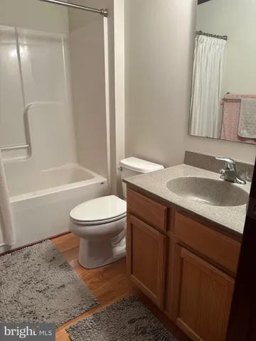 a bedroom with a large bed and a large window with wooden floor