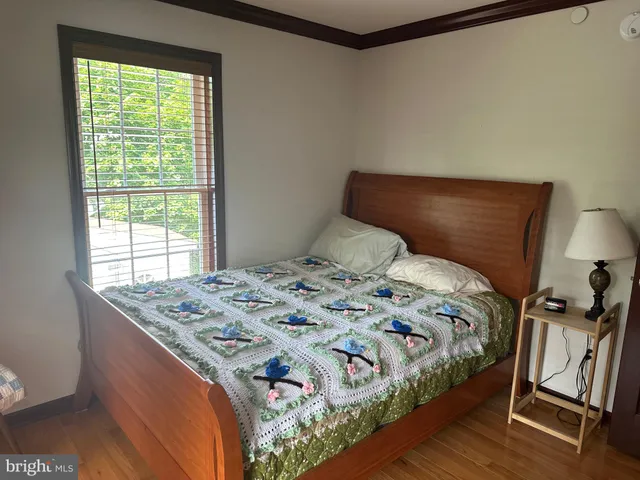 a bed sitting in a bedroom next to a window