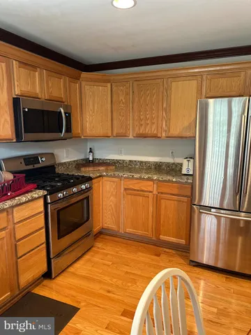 a kitchen with a sink stove and microwave