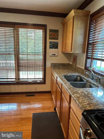 a kitchen with stainless steel appliances granite countertop a refrigerator stove and sink