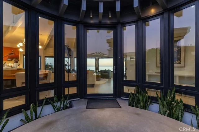 a living room with furniture and floor to ceiling window