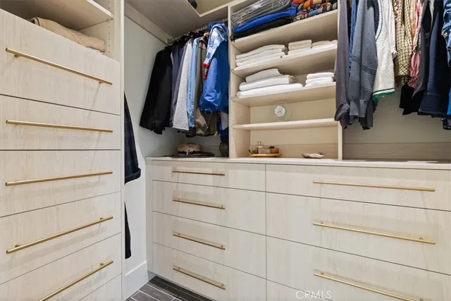 a view of a patio with couches table and chairs and potted plants