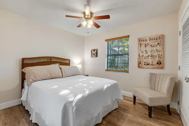 a bedroom with a bed and a chair