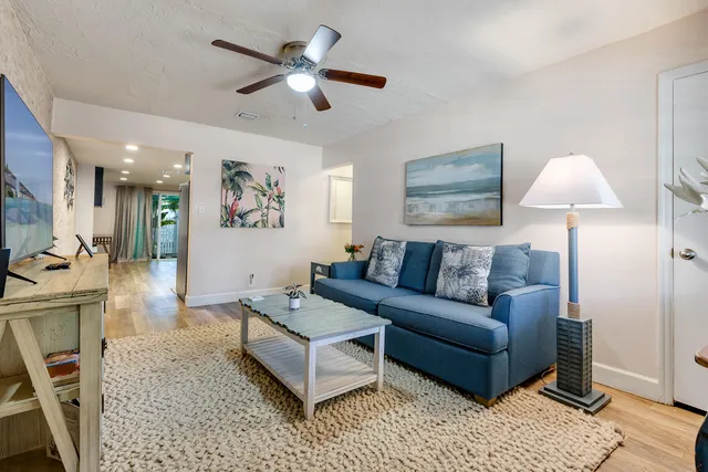 a living room with furniture a window and a lamp