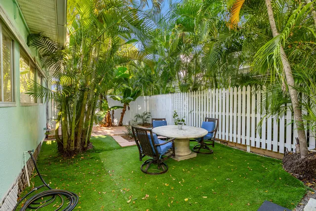 a view of a backyard with table and chairs and a slide