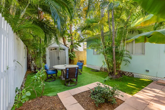 a view of a house with backyard sitting area and garden