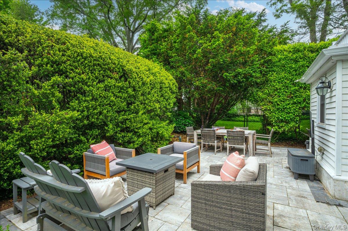 49 Eton Road Larchmont, NY 10538 - Photo 27 of 34 a view of a patio with table and chairs potted plants with wooden floor and fence