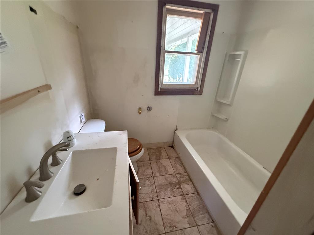 3051 Keystone Street Bethlehem, PA 18020 - Photo 7 of 18 A compact bathroom featuring a full bathtub and vanity with a single sink.