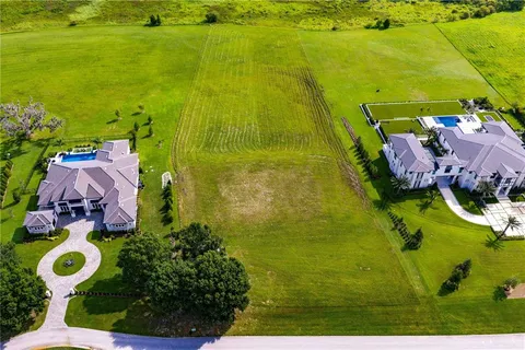a view of a lake with houses in the back