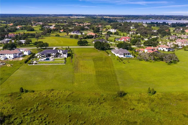 an aerial view of a houses with a lake view
