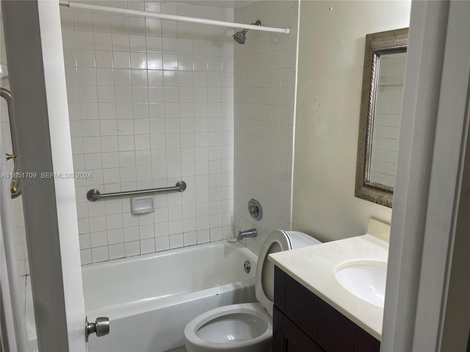 3252 Foxcroft Road, Unit 206 Miramar, FL 33025 - Photo 8 of 10 a bathroom with a sink toilet and shower