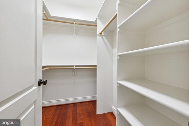 a view of an empty room with a fireplace and a large window