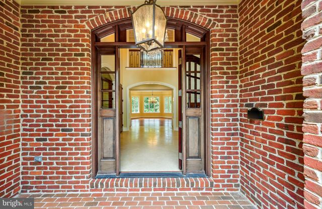 a view of an empty room with wooden floor and next to a window