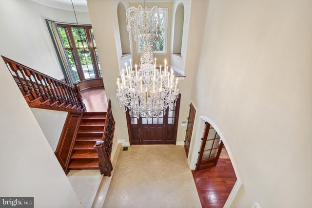 a view of kitchen with granite countertop a sink and a wooden cabinets