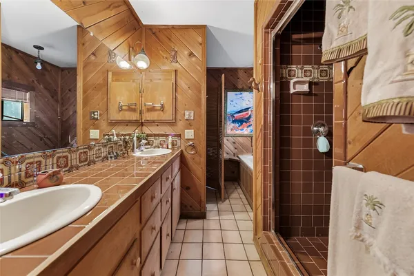 a bathroom with a sink double vanity and a shower