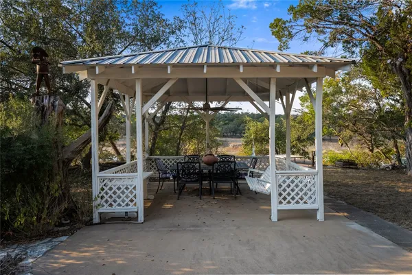 a patio with patio a table and chairs under an umbrella
