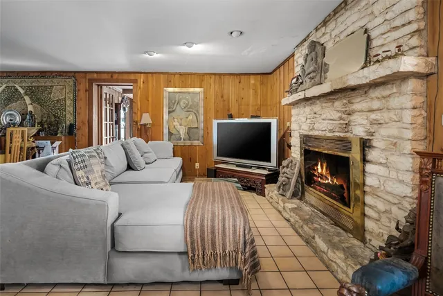 a living room with furniture a flat screen tv and a fireplace