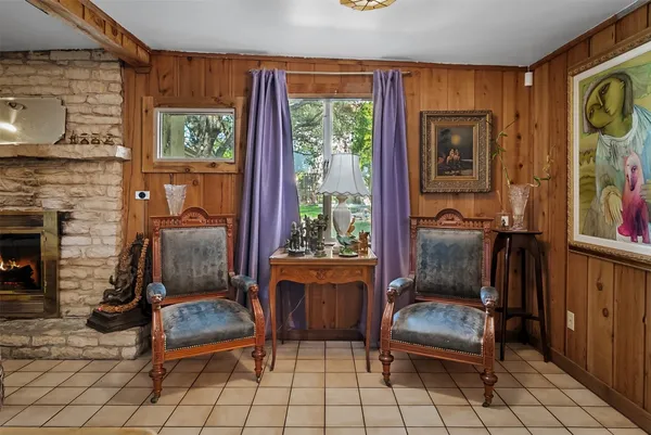 a living room with furniture a window and a fireplace