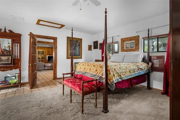 a bedroom with a bed a table and chair