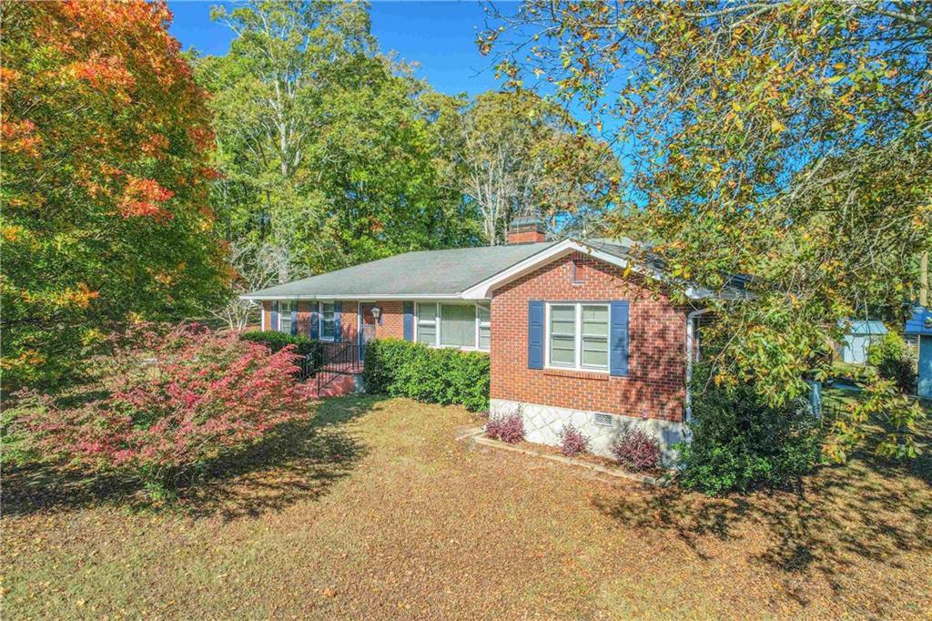 3749 Centerville Rosebud Road Snellville, GA 30039 - Photo 1 of 77 a front view of a house with a yard and garage