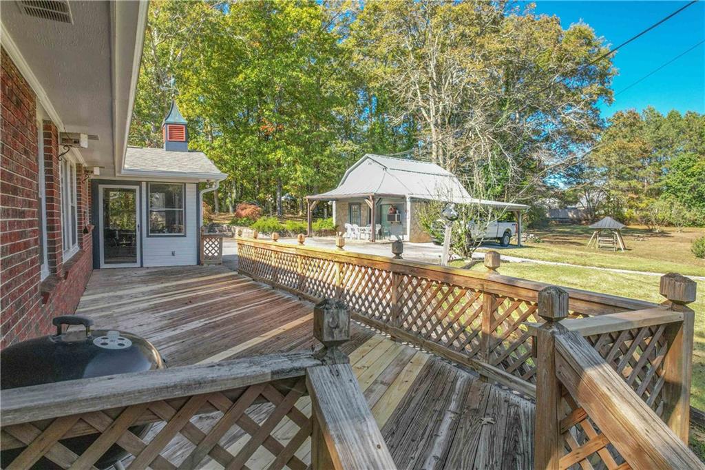 3749 Centerville Rosebud Road Snellville, GA 30039 - Photo 47 of 77 a view of a patio with a table chairs and a barbeque
