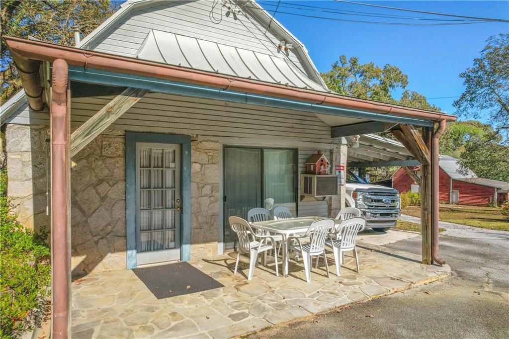 3749 Centerville Rosebud Road Snellville, GA 30039 - Photo 69 of 77 a view of a patio with a table and chairs and potted plants