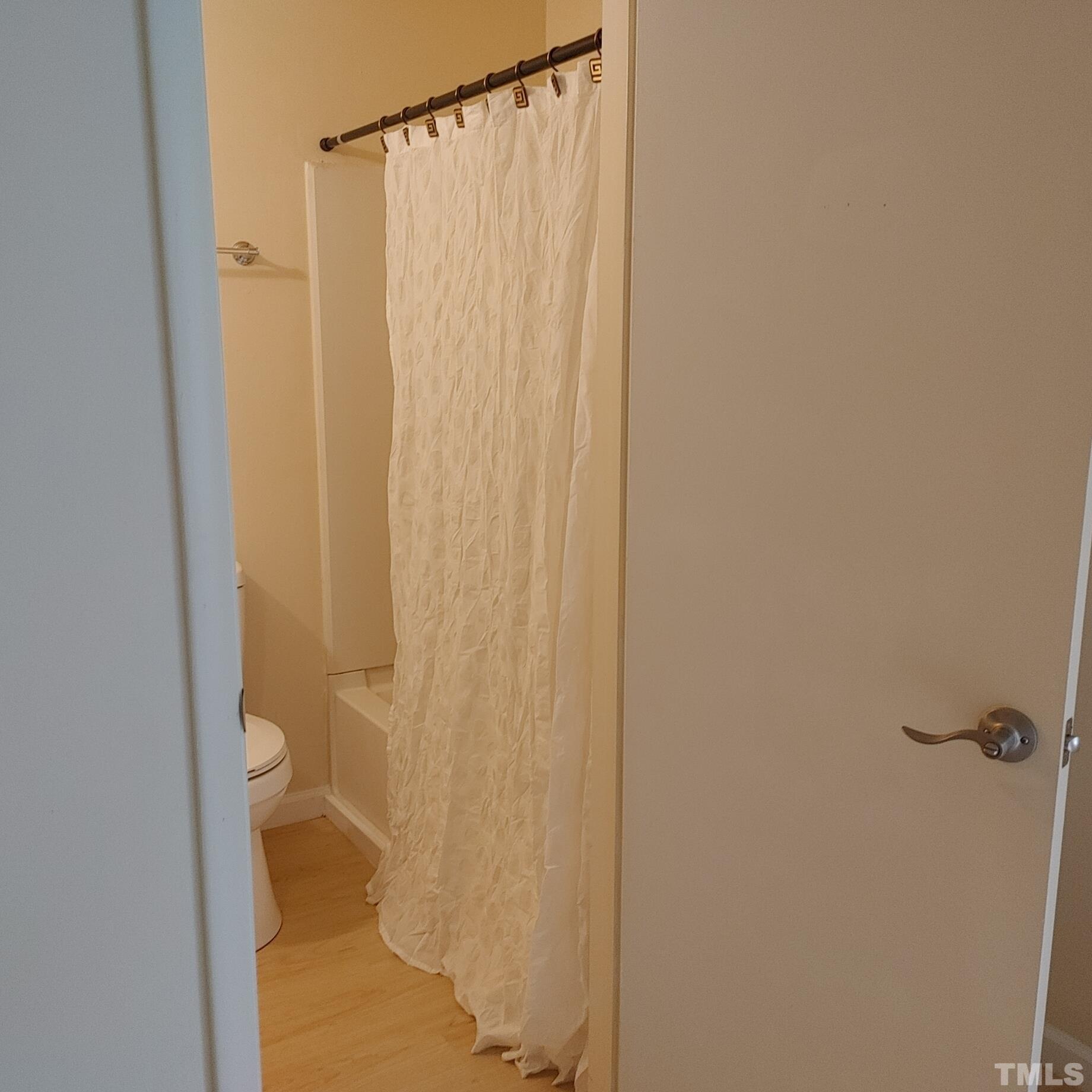 1431 Collegiate Circle, Unit 301 Raleigh, NC 27606 - Photo 3 of 30 a bathroom with a shower curtain
