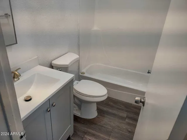 a bathroom with a toilet a sink and bathtub