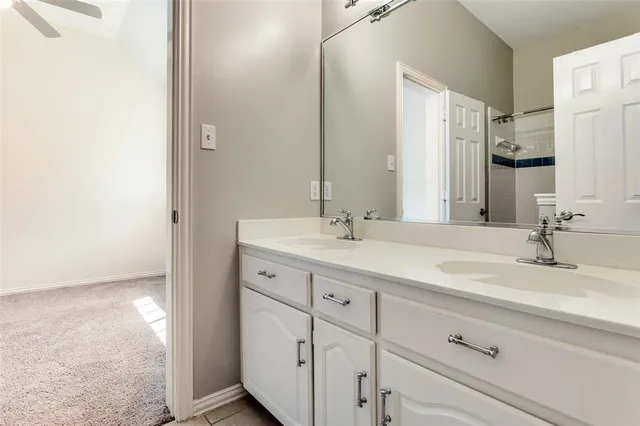 a bathroom with a double vanity sink and a mirror