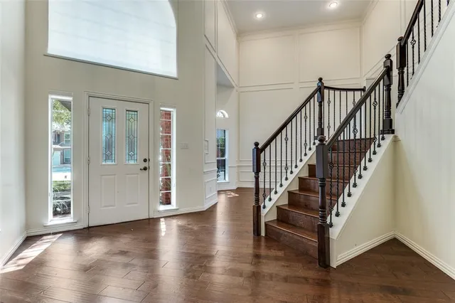 a view of entryway with wooden floor and stairs