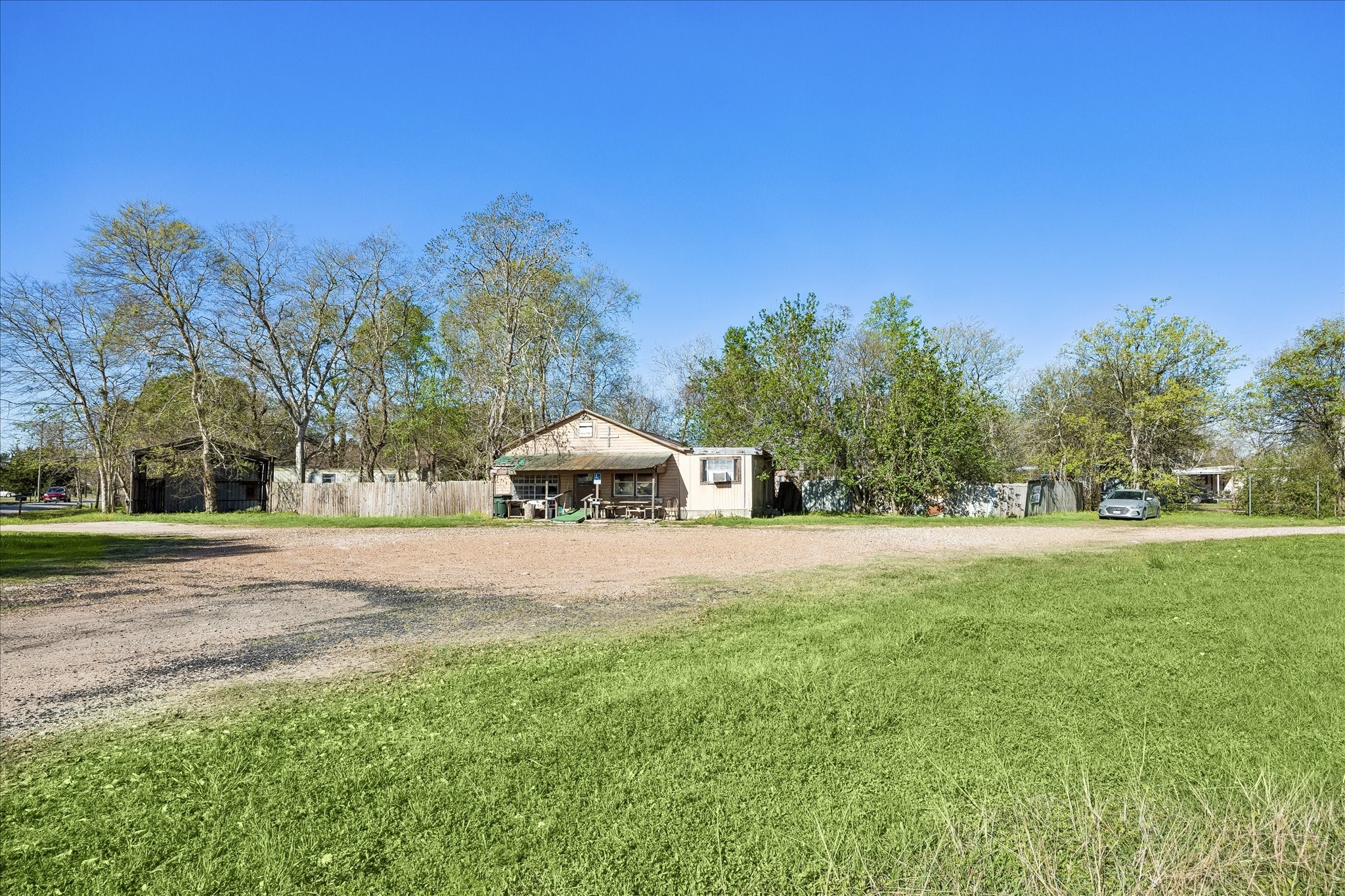 805 Frydek Road Sealy, TX 77474 - Photo 5 of 8 a tall yellow house with a big yard and large trees