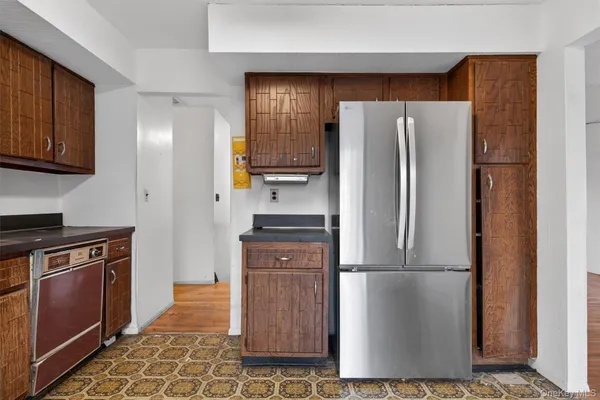 a kitchen with stainless steel appliances granite countertop a refrigerator a stove a sink and dishwasher