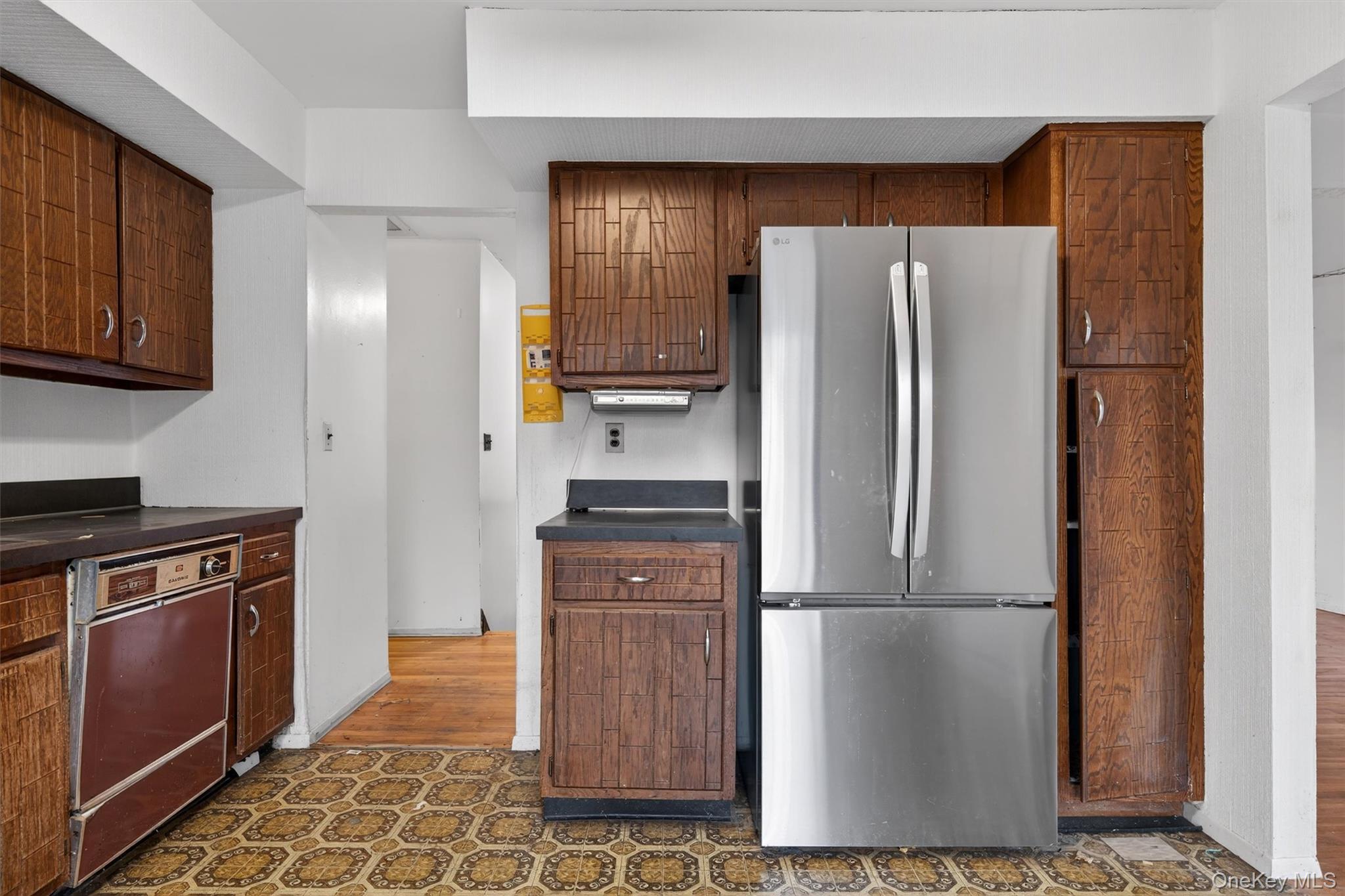 53 Mallory Road Spring Valley, NY 10977 - Photo 13 of 33 Kitchen featuring dark countertops and freestanding refrigerator