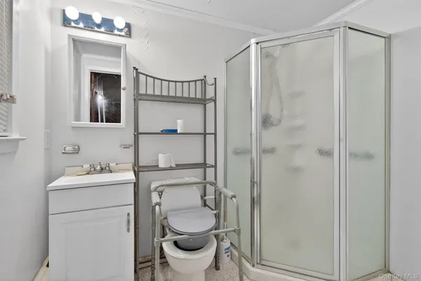 a bathroom with a toilet sink vanity and mirror