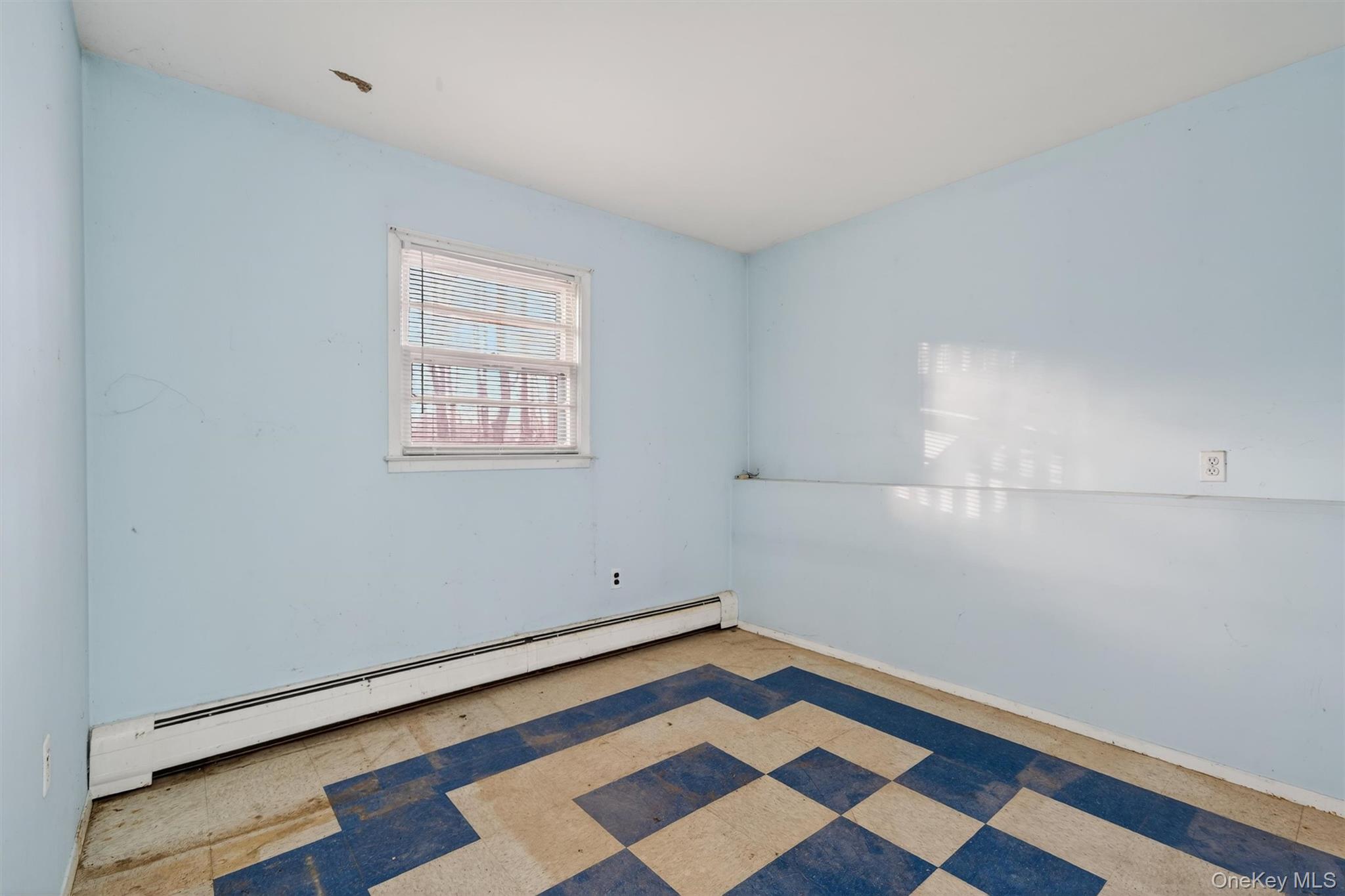 53 Mallory Road Spring Valley, NY 10977 - Photo 27 of 33 Spare room featuring a baseboard heating unit and baseboards