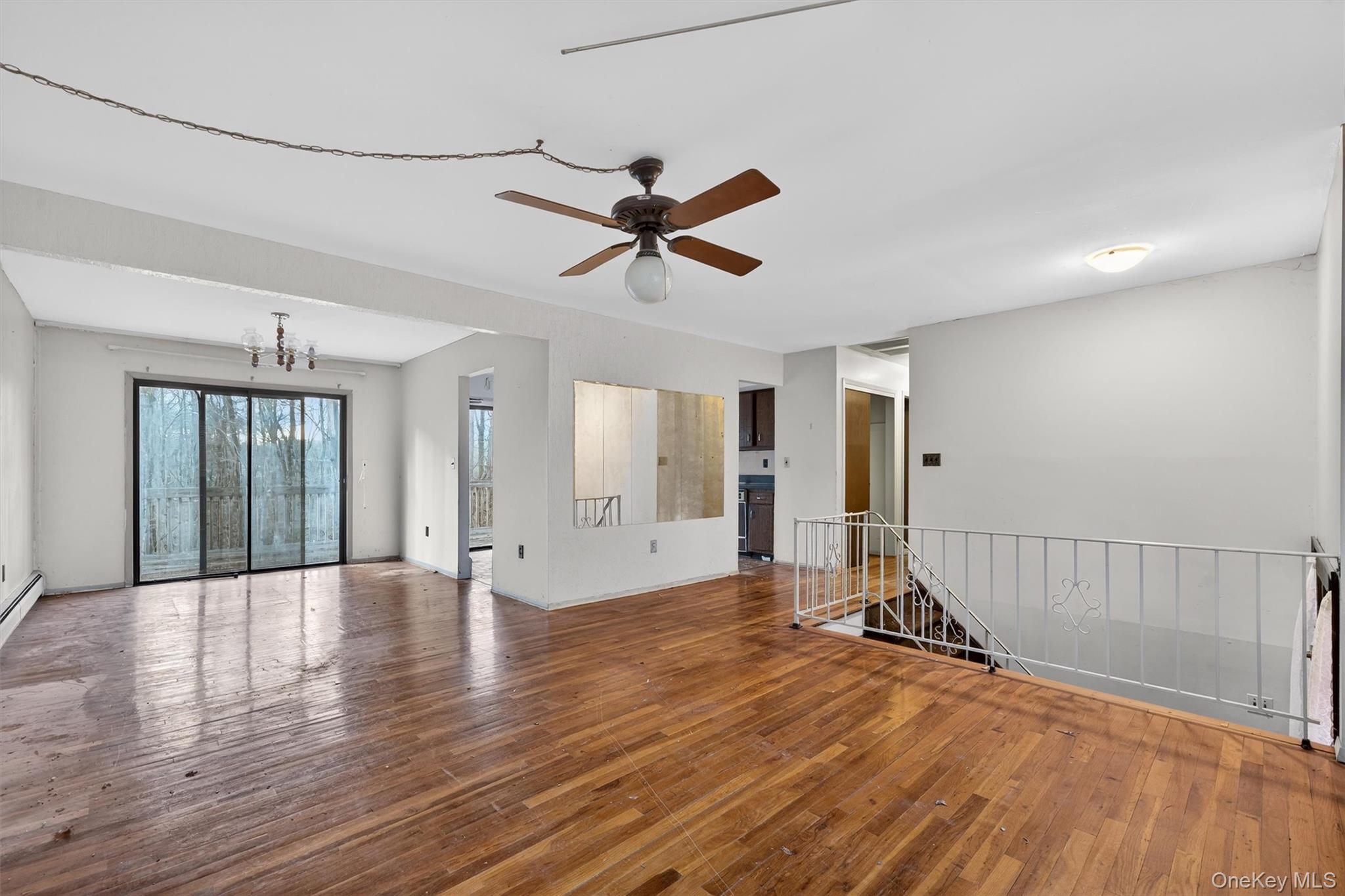 53 Mallory Road Spring Valley, NY 10977 - Photo 7 of 33 Empty room featuring hardwood / wood-style floors, a chandelier, and ceiling fan