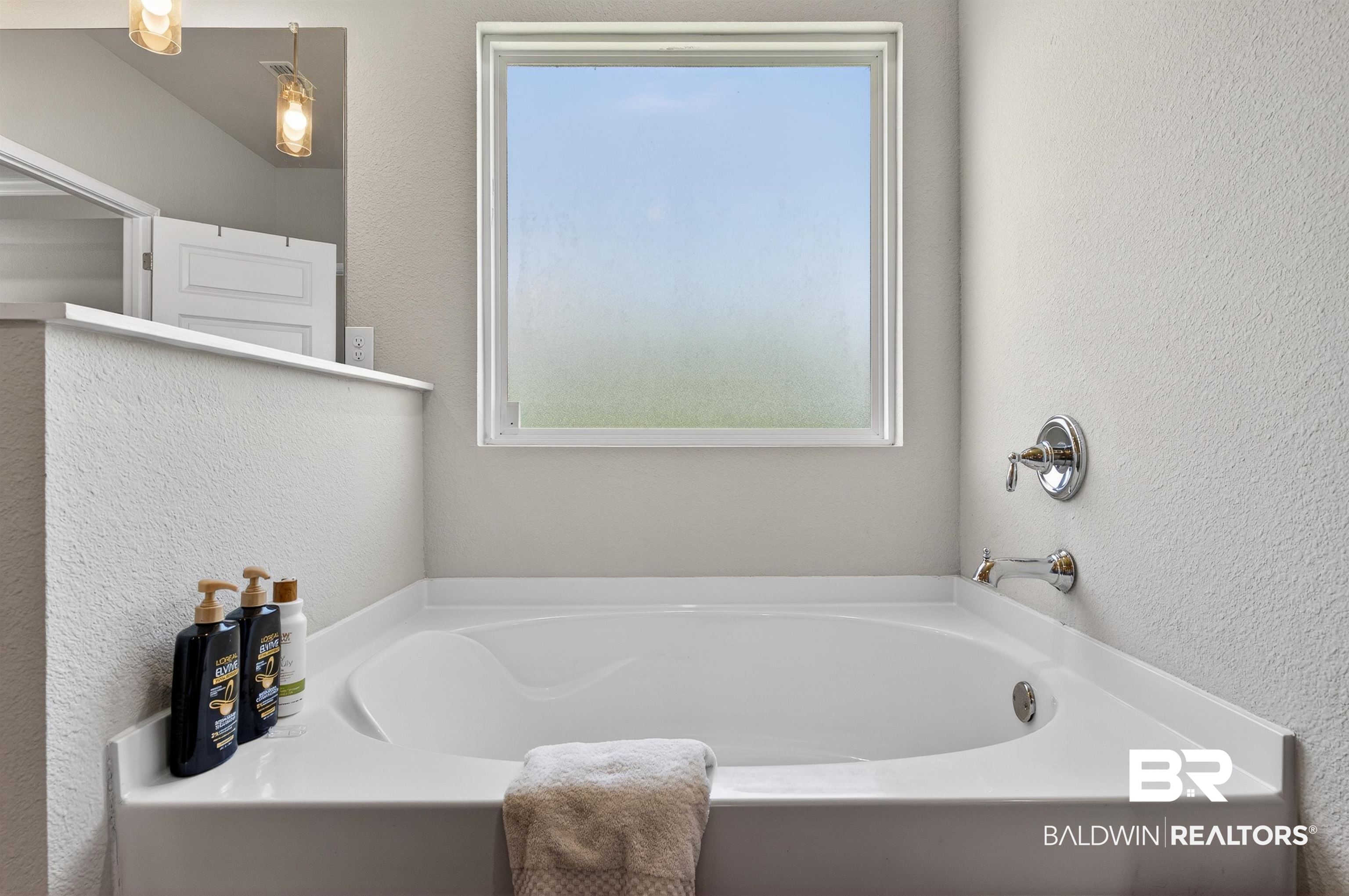 8735 Bronze Lane Foley, AL 36535 - Photo 26 of 58 Built-in soaking tub featuring chrome fixtures and a privacy window