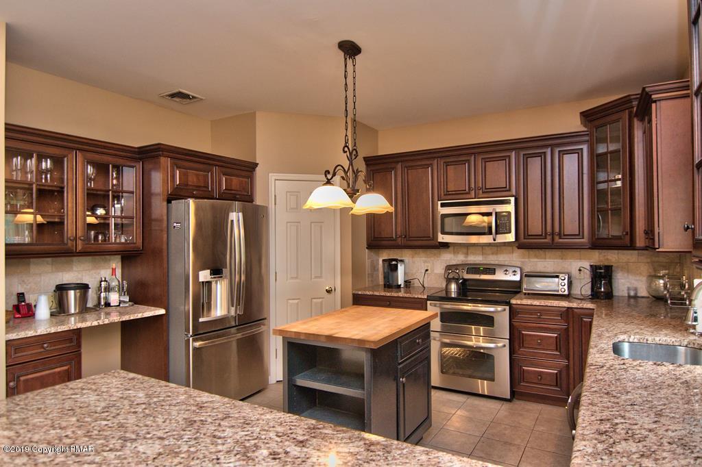 2169 Fox Run Road Stroudsburg, PA 18360 - Photo 15 of 66 a kitchen with stainless steel appliances granite countertop a stove refrigerator and cabinets