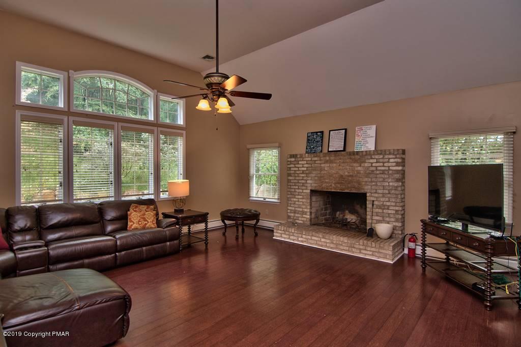 2169 Fox Run Road Stroudsburg, PA 18360 - Photo 21 of 66 a living room with furniture a fireplace a flat screen tv and a large window