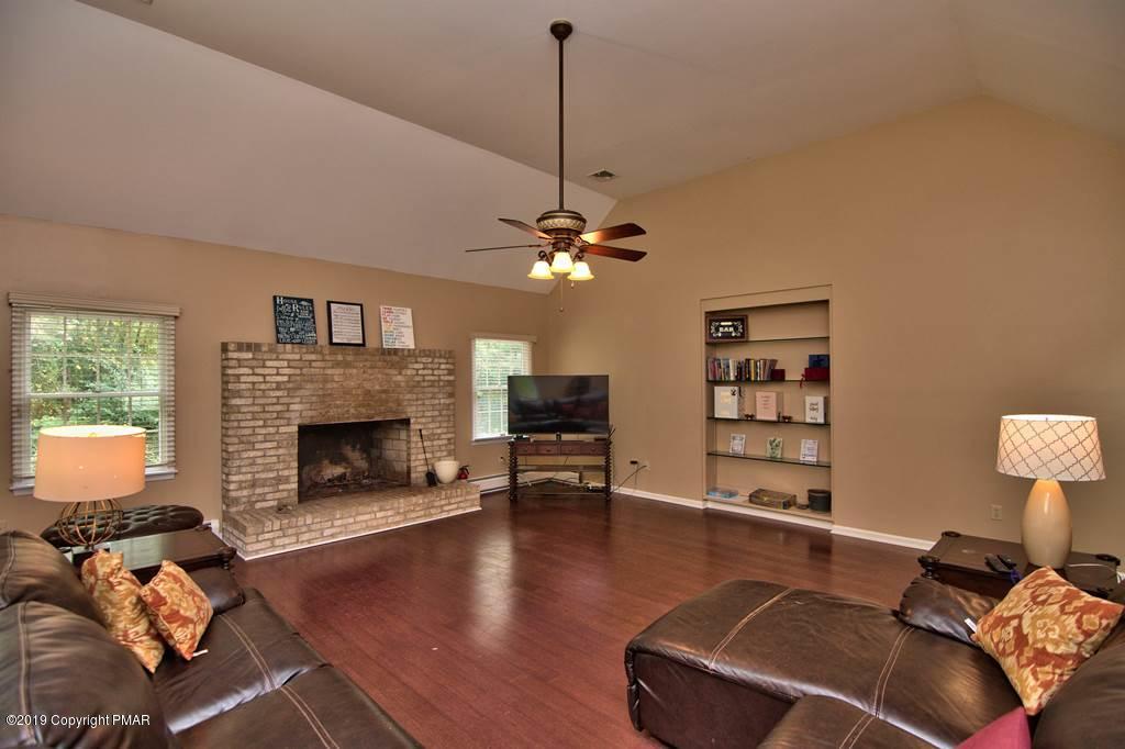 2169 Fox Run Road Stroudsburg, PA 18360 - Photo 24 of 66 a living room with furniture and a fireplace