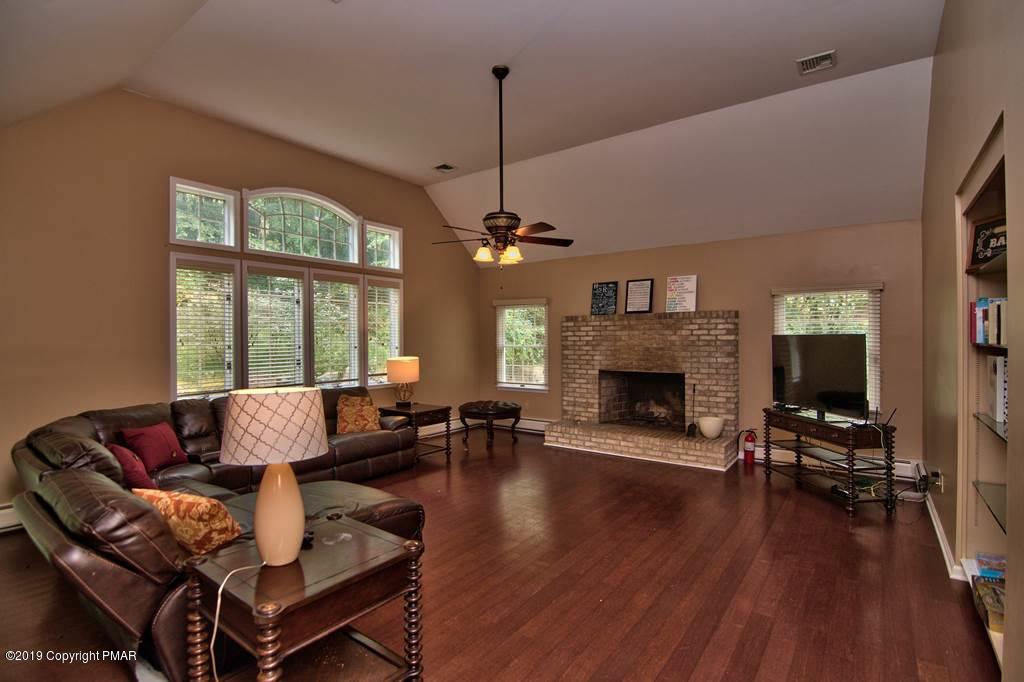2169 Fox Run Road Stroudsburg, PA 18360 - Photo 25 of 66 a living room with furniture a large window and a fireplace