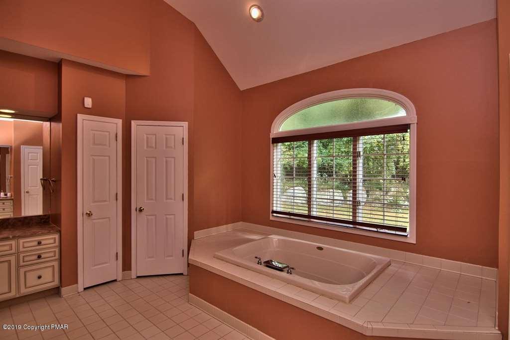 2169 Fox Run Road Stroudsburg, PA 18360 - Photo 29 of 66 a bathroom with a tub a sink and a window