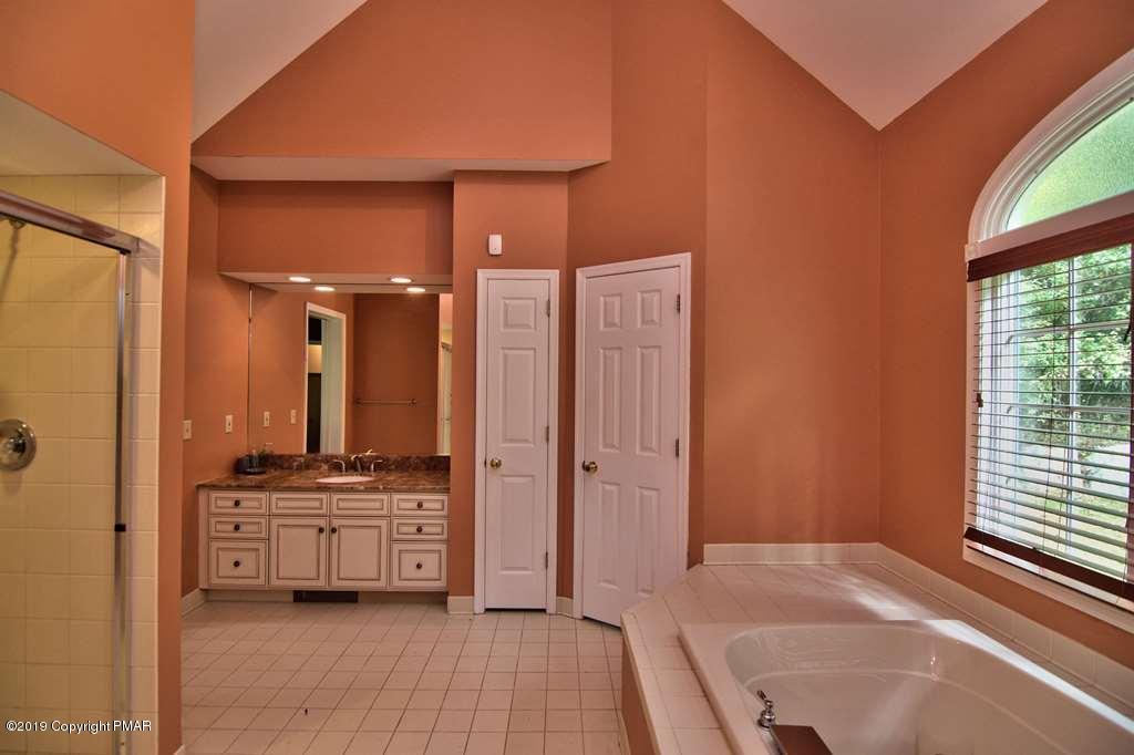 2169 Fox Run Road Stroudsburg, PA 18360 - Photo 30 of 66 a spacious bathroom with a double vanity sink a mirror and a shower