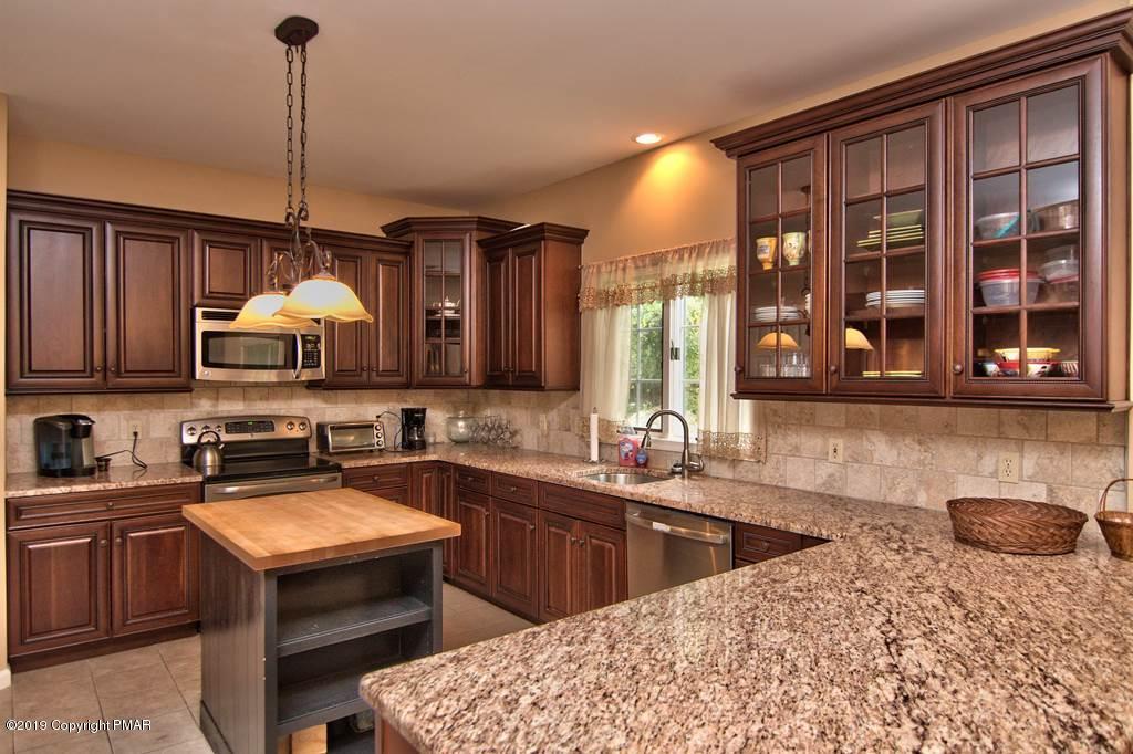 2169 Fox Run Road Stroudsburg, PA 18360 - Photo 3 of 66 a kitchen with stainless steel appliances granite countertop a sink a stove and a wooden floors