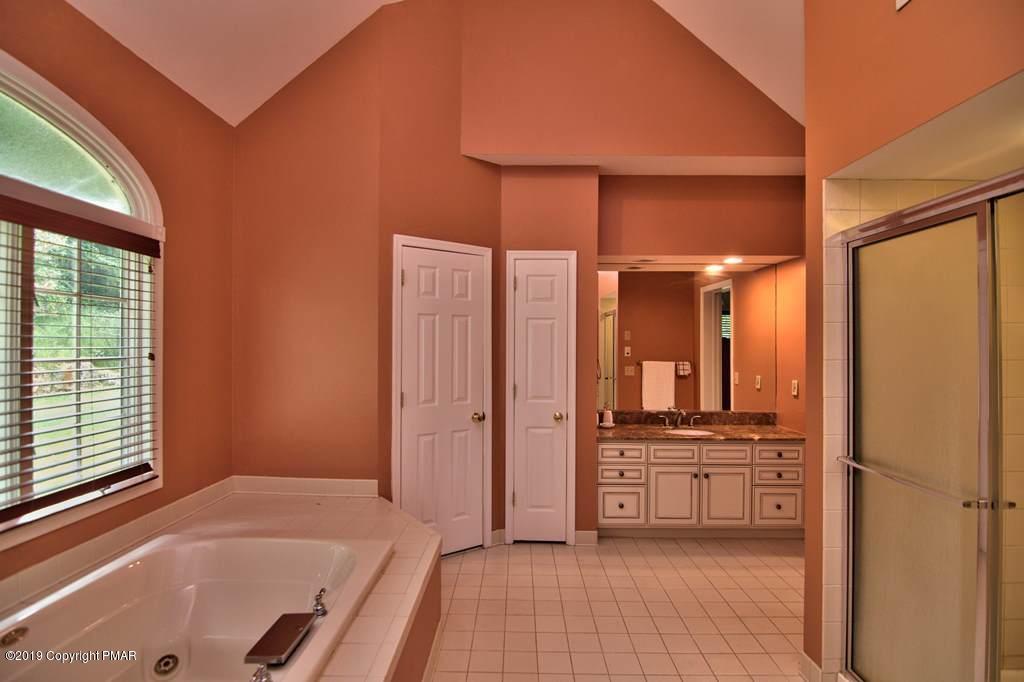2169 Fox Run Road Stroudsburg, PA 18360 - Photo 32 of 66 a bathroom with a tub sink and mirror